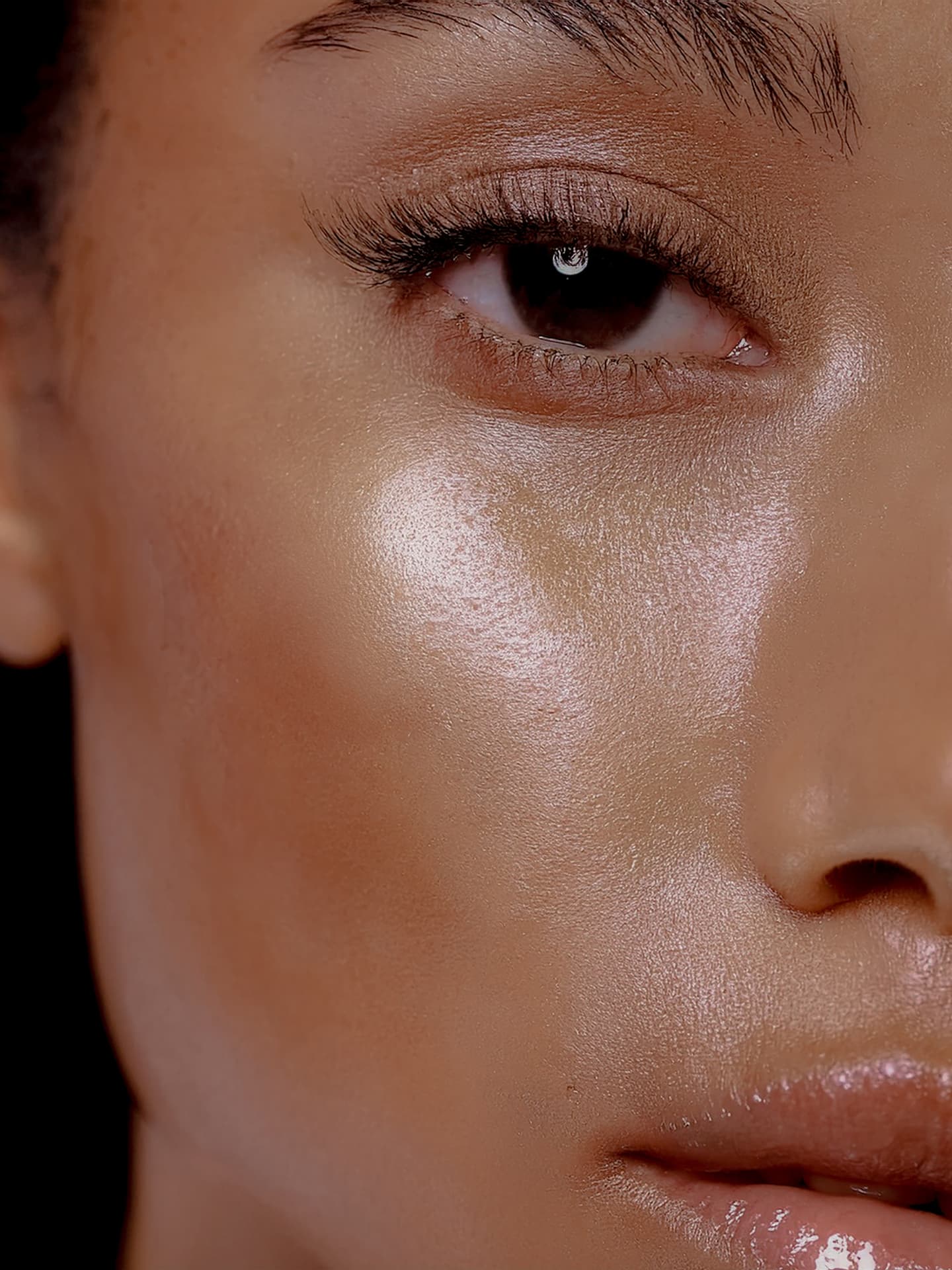 Macro detail of luminous cheek and dewy skin finish